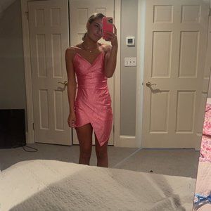 Very sparkly, tight, pink dress.